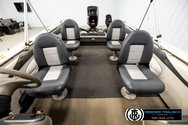 Slide: The Image of Interior of a 2004 Crestliner 2050 Sportfish boat with four seats and steering wheel. - 16
