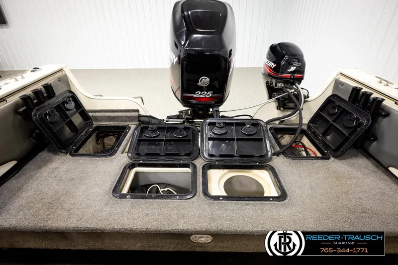 Slide: The Image of 2004 Crestliner 2050 Sportfish boat interior with Mercury outboard motors and storage compartments. - 18