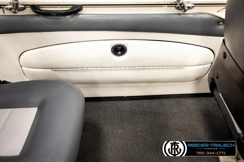 Slide: The Image of 2004 Crestliner 2050 Sportfish interior with gray and white seating, carpeted floor. - 19