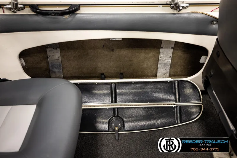 Slide: The Image of 2004 Crestliner 2050 Sportfish interior storage compartment with seating and carpeted flooring. - 20