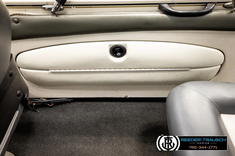 Slide: The Image of Interior view of a 2004 Crestliner 2050 Sportfish boat, featuring seating and storage. - 21