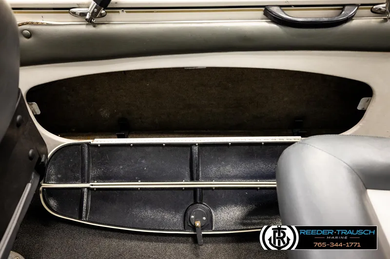 Slide: The Image of 2004 Crestliner 2050 Sportfish interior storage compartment with measuring ruler and seating. - 22