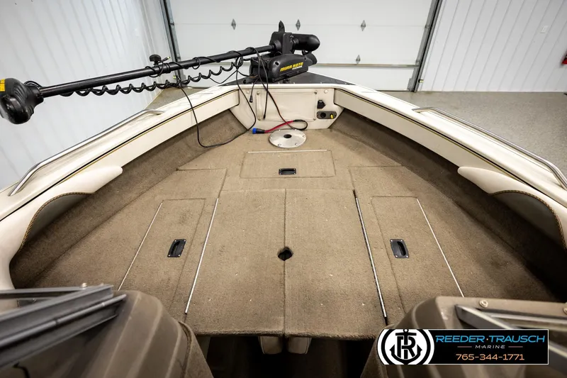 Slide: The Image of 2004 Crestliner 2050 Sportfish boat interior with trolling motor and carpeted deck. - 24