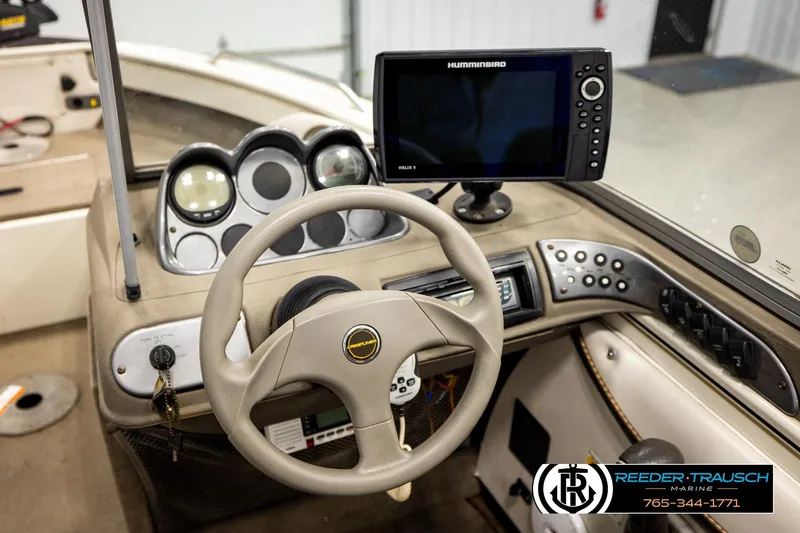 Slide: The Image of 2004 Crestliner 2050 Sportfish boat dashboard with steering wheel and Humminbird electronics. - 27