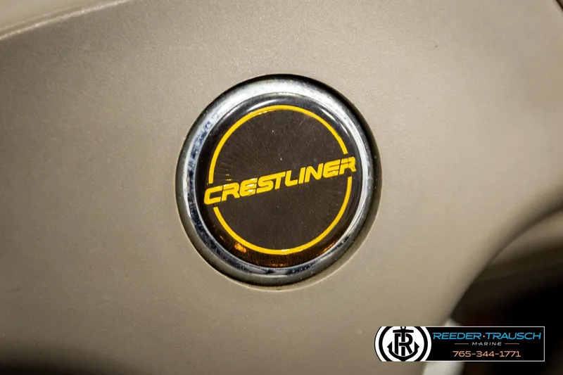 Slide: The Image of Crestliner 2050 Sportfish 2004 logo on beige background, Reeder-Trausch Marine branding. - 28