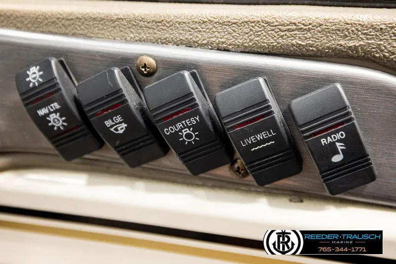 Slide: The Image of Control panel switches on a 2004 Crestliner 2050 Sportfish boat. - 34