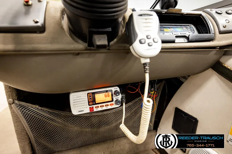 Slide: The Image of 2004 Crestliner 2050 Sportfish dashboard with marine radio and control panel. - 35