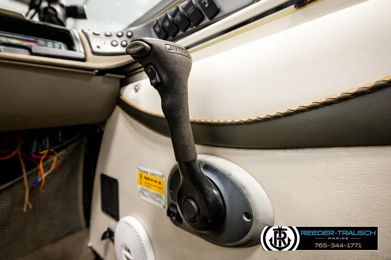 Slide: The Image of 2004 Crestliner 2050 Sportfish boat interior with control lever and dashboard details. - 37