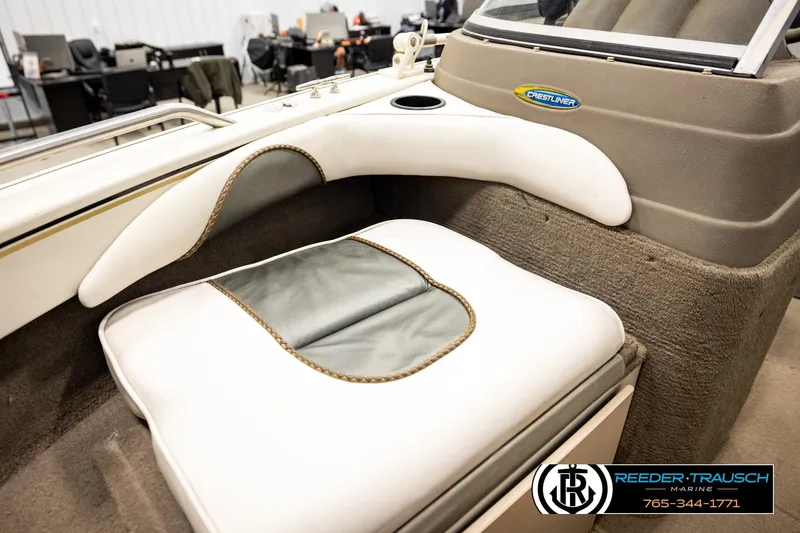 Slide: The Image of 2004 Crestliner 2050 Sportfish boat interior with cushioned seating and dashboard details. - 39