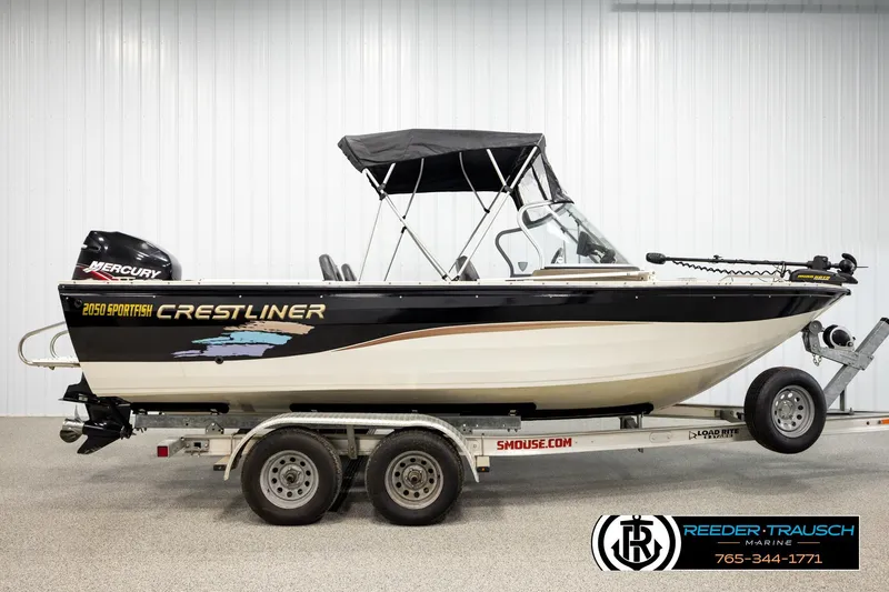 Slide: The Image of 2004 Crestliner 2050 Sportfish boat on trailer, featuring a Mercury engine. - 4