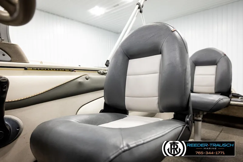 Slide: The Image of 2004 Crestliner 2050 Sportfish boat interior with gray and white seating in a showroom. - 41