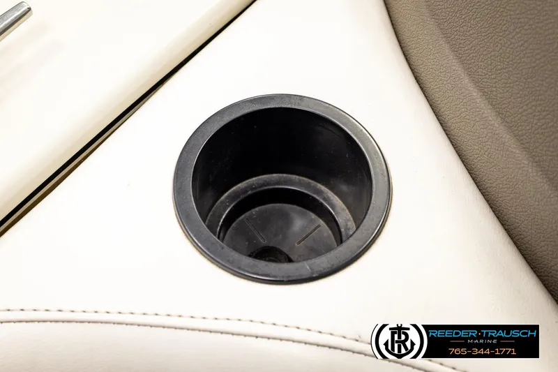 Slide: The Image of Cup holder on 2004 Crestliner 2050 Sportfish boat interior, featuring beige upholstery. - 43