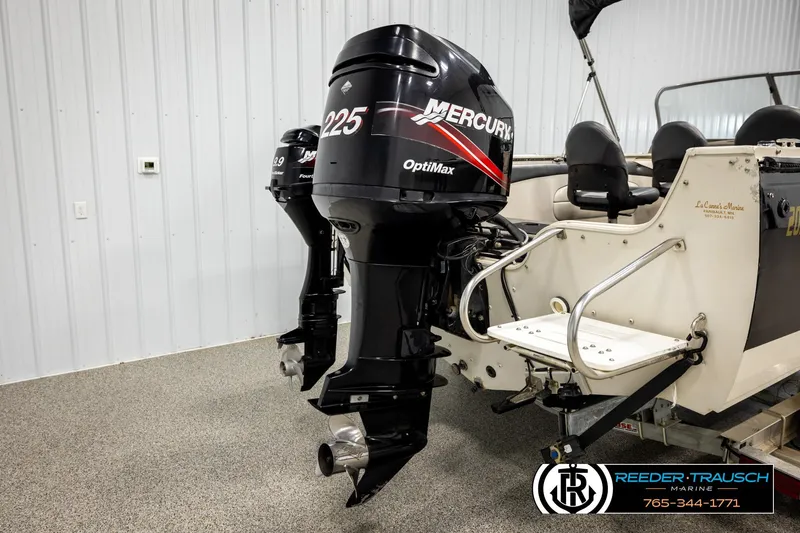 Slide: The Image of 2004 Crestliner 2050 Sportfish boat with dual Mercury outboard motors in a showroom. - 49