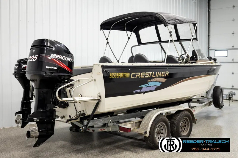 Slide: The Image of 2004 Crestliner 2050 Sportfish boat on trailer with Mercury outboard engines in a garage. - 5