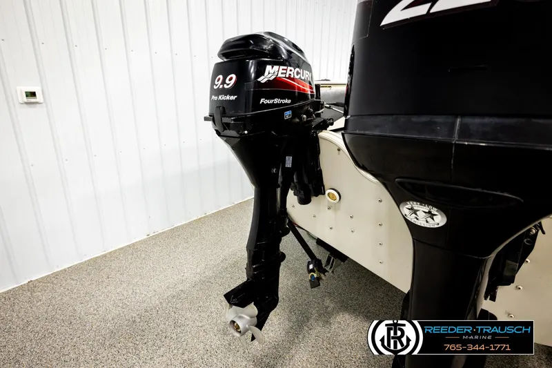 Slide: The Image of 2004 Crestliner 2050 Sportfish with Mercury 9.9 Pro Kicker outboard motor in showroom. - 53