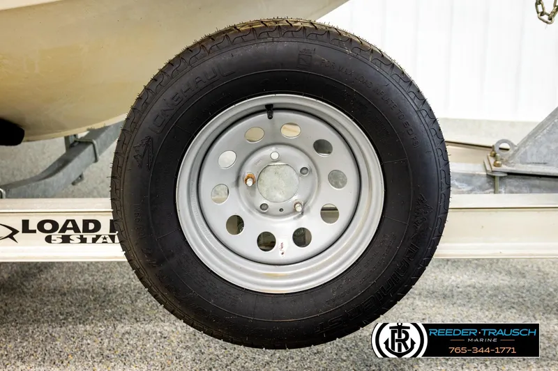 Slide: The Image of Trailer wheel of a 2004 Crestliner 2050 Sportfish boat on Load Rite trailer. - 57