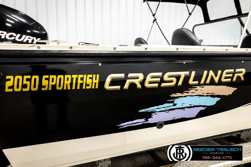 Slide: The Image of 2004 Crestliner 2050 Sportfish boat with bold lettering and colorful graphics. - 59
