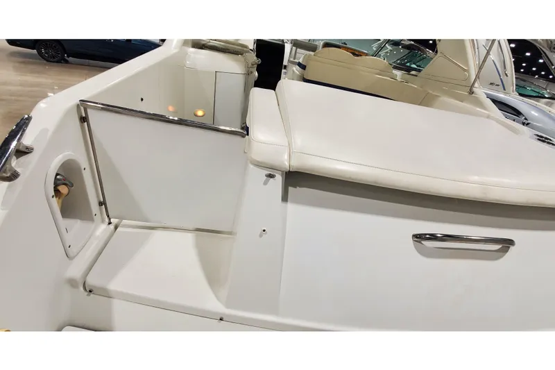 Slide: The Image of 2006 Formula 330 Sun Sport boat interior with white seating and open door. - 11