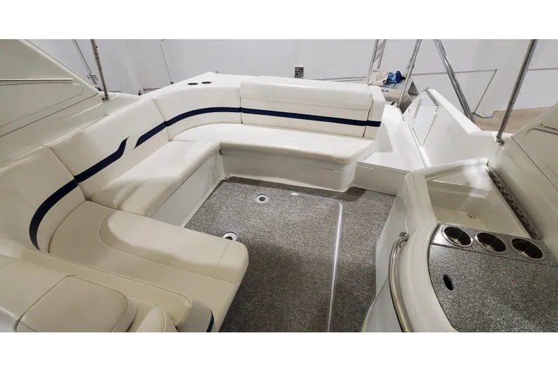 Slide: The Image of 2006 Formula 330 Sun Sport boat interior with white seating and cup holders. - 15