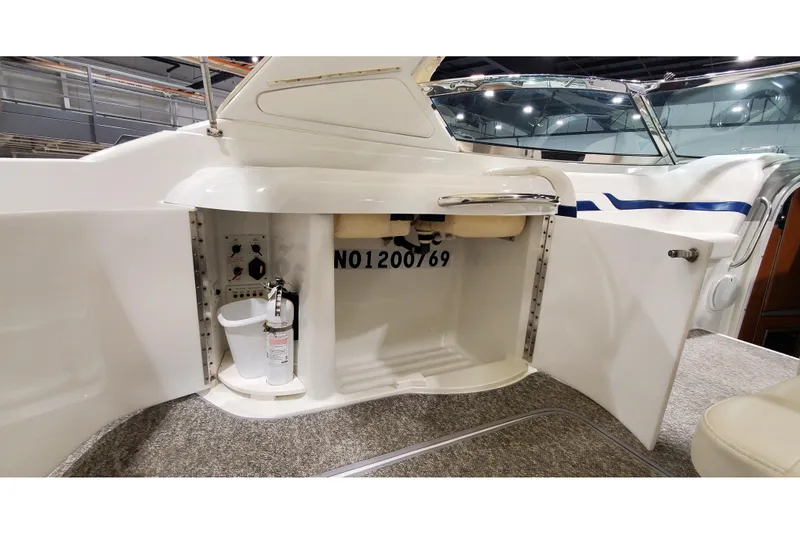Slide: The Image of 2006 Formula 330 Sun Sport boat interior storage compartment with fire extinguisher. - 17