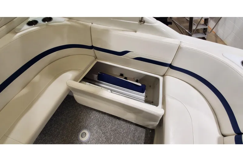 Slide: The Image of 2006 Formula 330 Sun Sport boat interior with open storage compartment and cushioned seating. - 18