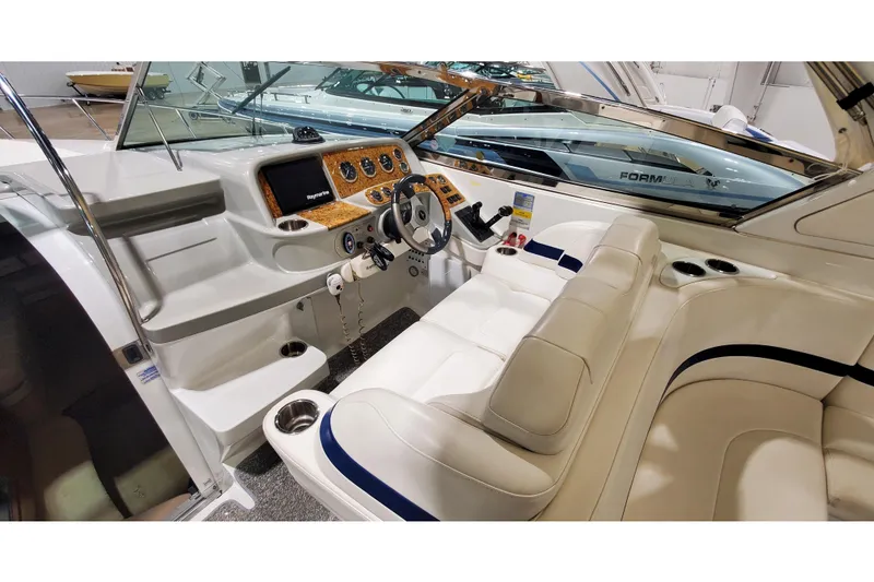 Slide: The Image of 2006 Formula 330 Sun Sport boat interior with steering wheel and dashboard. - 19