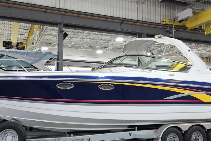 Slide: The Image of 2006 Formula 330 Sun Sport boat on trailer in indoor facility. - 2