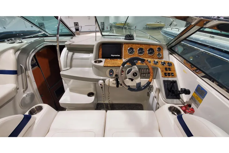 Slide: The Image of 2006 Formula 330 Sun Sport boat cockpit with steering wheel and control panel. - 20