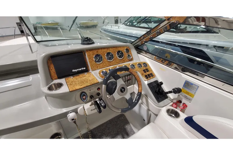 Slide: The Image of 2006 Formula 330 Sun Sport boat dashboard with steering wheel and navigation controls. - 21