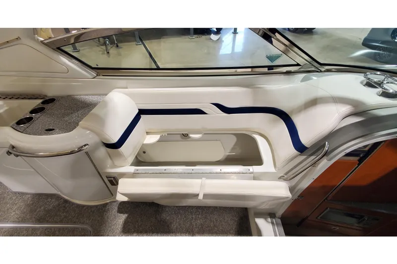 Slide: The Image of Interior of a 2006 Formula 330 Sun Sport boat, featuring white seating with blue accents. - 23