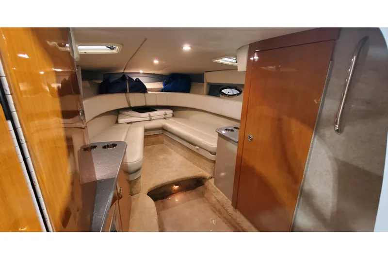 Slide: The Image of Interior of 2006 Formula 330 Sun Sport boat with cozy seating and wooden cabinetry. - 24