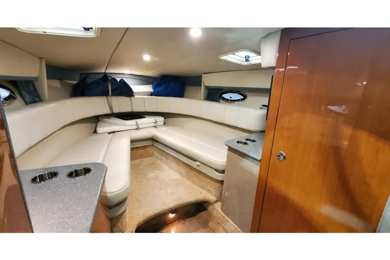 Slide: The Image of Interior of 2006 Formula 330 Sun Sport boat with plush seating and wood accents. - 25