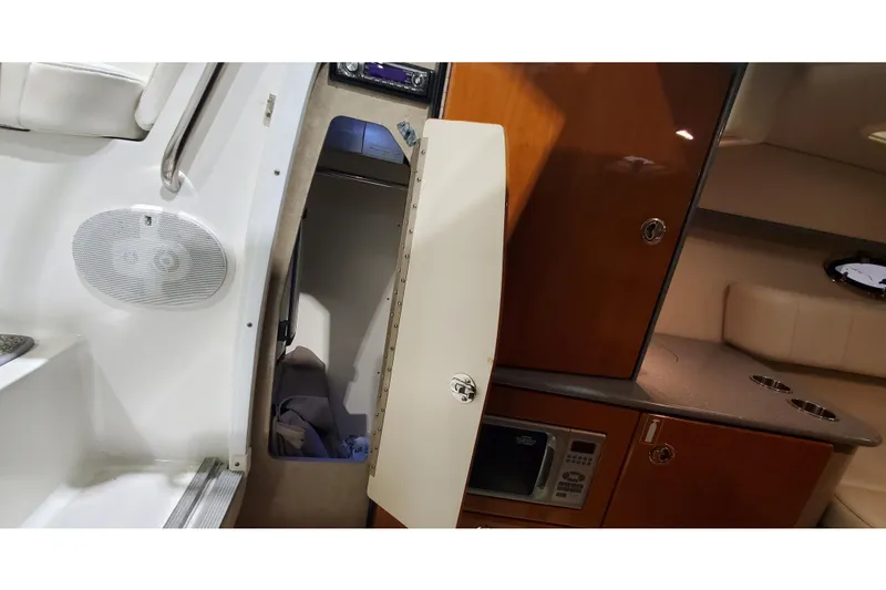 Slide: The Image of Interior of 2006 Formula 330 Sun Sport boat with kitchenette and seating area. - 27