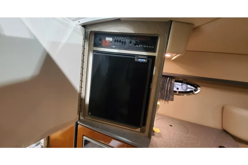 Slide: The Image of 2006 Formula 330 Sun Sport cabin interior with compact refrigerator and control panel. - 28