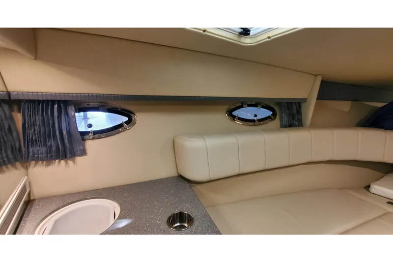 Slide: The Image of Interior of 2006 Formula 330 Sun Sport boat with beige seating and porthole windows. - 30