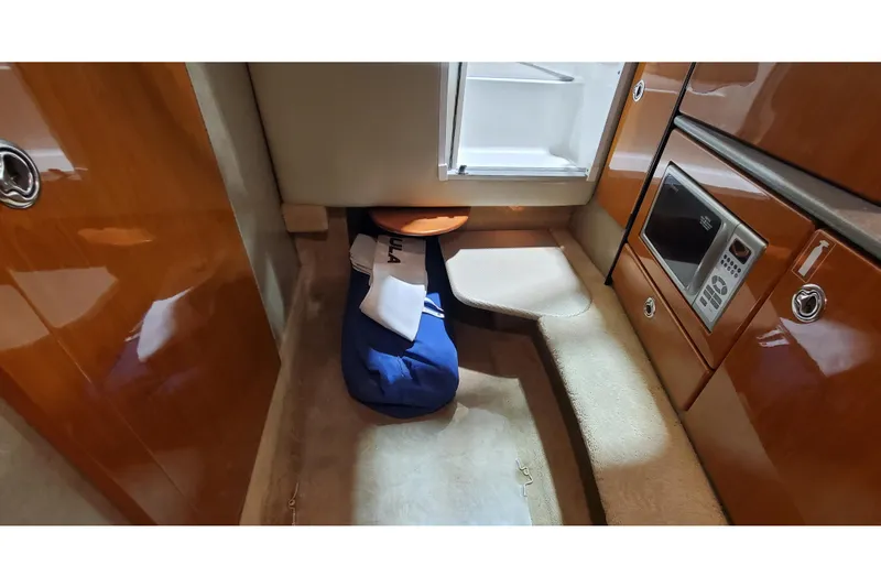Slide: The Image of Interior of a 2006 Formula 330 Sun Sport boat with microwave and storage area. - 32