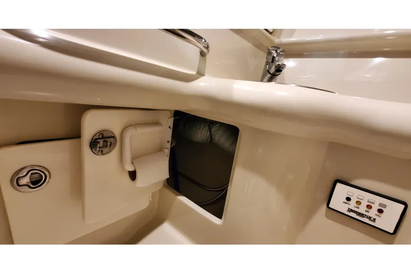 Slide: The Image of Interior view of a 2006 Formula 330 Sun Sport boat, showcasing control panel and storage compartment. - 34