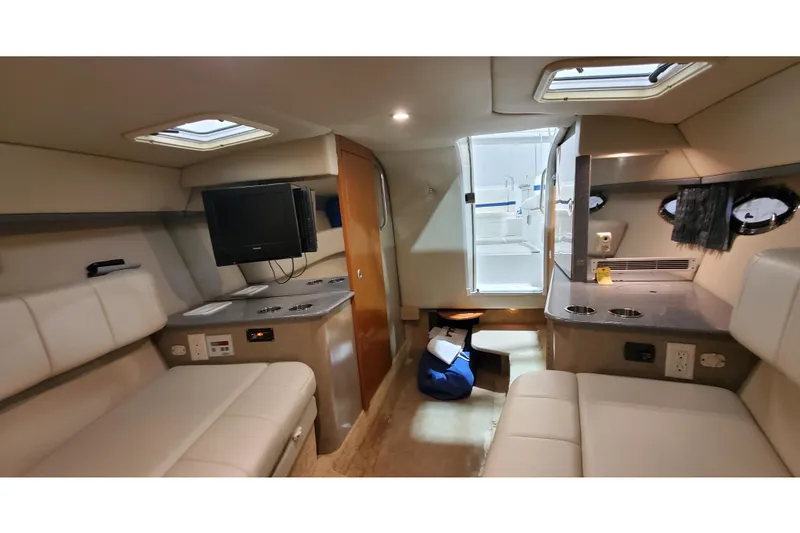 Slide: The Image of Interior of 2006 Formula 330 Sun Sport boat with seating, TV, and portholes. - 36