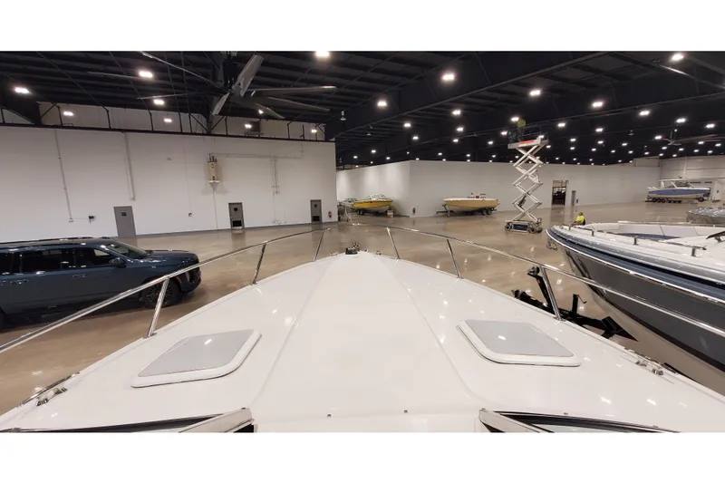Slide: The Image of 2006 Formula 330 Sun Sport boat in indoor showroom with other boats and vehicles. - 39