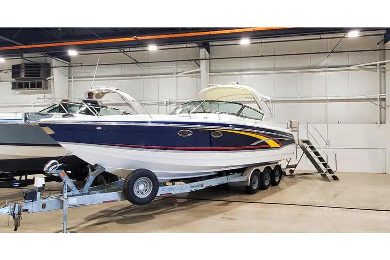 Slide: The Image of 2006 Formula 330 Sun Sport boat on trailer in indoor storage facility. - 4