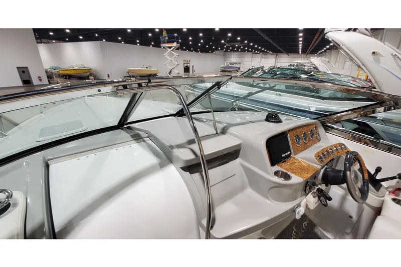 Slide: The Image of 2006 Formula 330 Sun Sport boat interior with steering wheel and dashboard in showroom. - 40