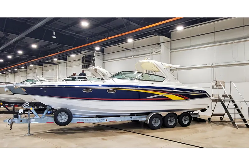 Slide: The Image of 2006 Formula 330 Sun Sport boat on trailer in indoor showroom. - 5