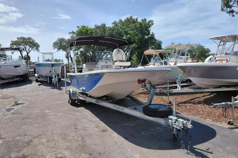 The Image of 2021 Carolina Skiff 21 LS boat on trailer, parked outdoors under clear sky. - 1