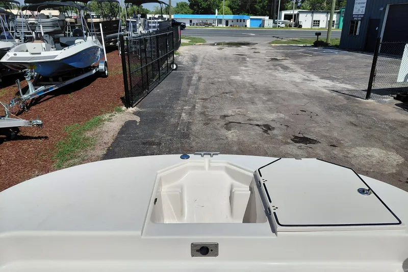 Slide: The Image of 2021 Carolina Skiff 21 LS boat at a dealership, surrounded by other boats. - 13