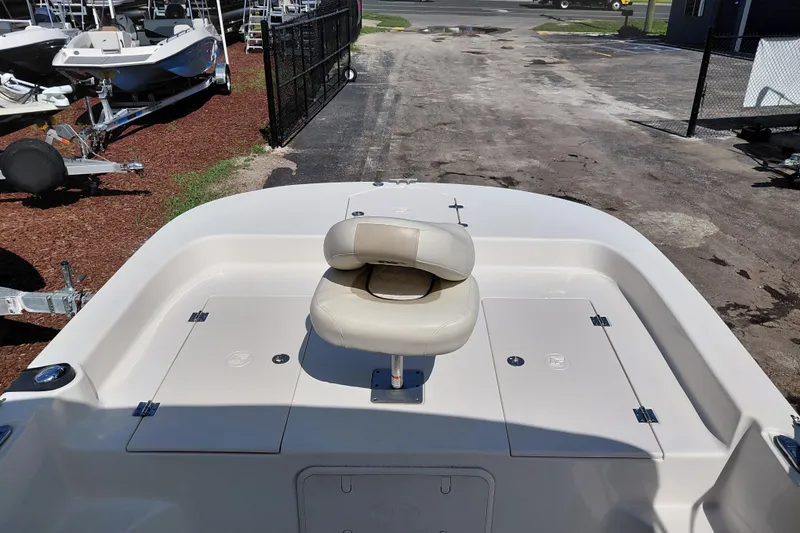 Slide: The Image of 2021 Carolina Skiff 21 LS boat with cushioned seating, parked on a lot. - 24