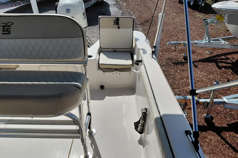 Slide: The Image of 2021 Carolina Skiff 21 LS boat interior with cushioned seating and fishing rod holders. - 26