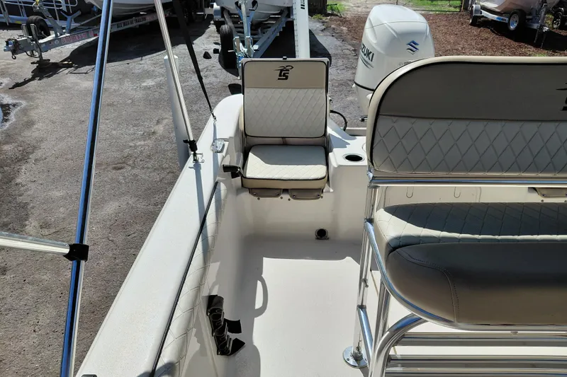 Slide: The Image of 2021 Carolina Skiff 21 LS boat interior with seating and Suzuki outboard motor. - 27
