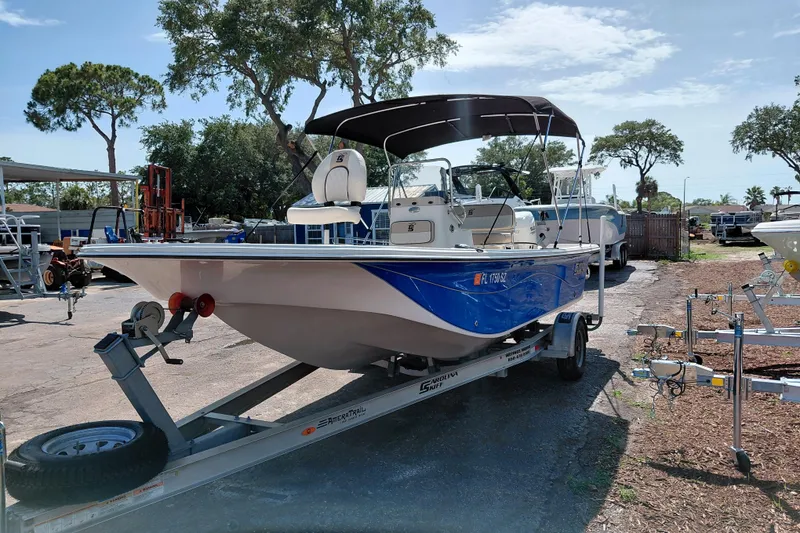 Slide: The Image of 2021 Carolina Skiff 21 LS boat on trailer, parked outdoors under sunny skies. - 3