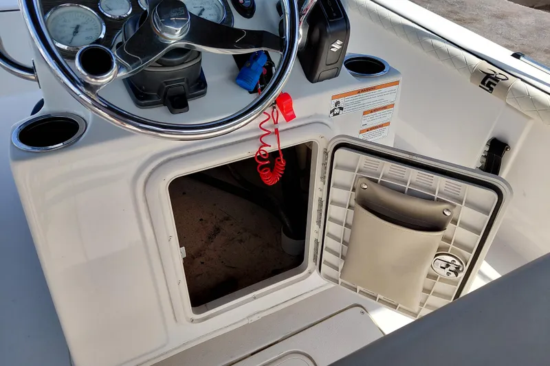 Slide: The Image of 2021 Carolina Skiff 21 LS boat console with open storage compartment and steering wheel. - 30