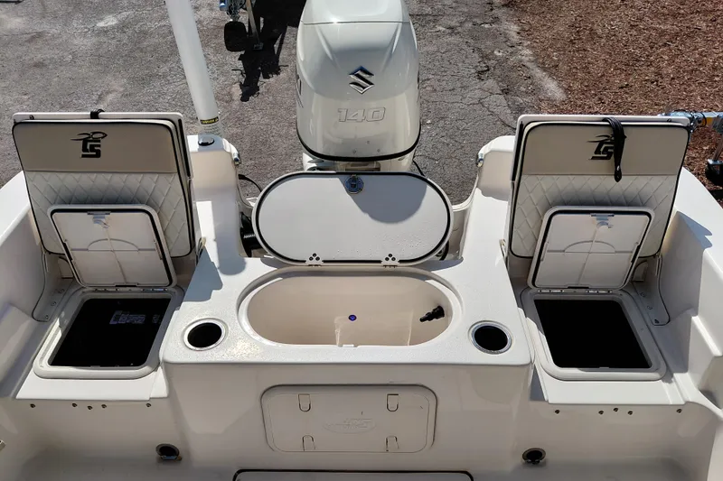 Slide: The Image of 2021 Carolina Skiff 21 LS boat interior with storage compartments and Suzuki 140 engine. - 33